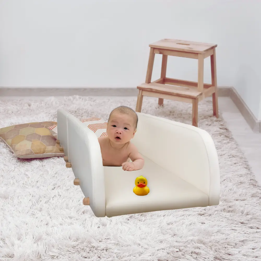 asian infant having fun during tummy time in the crawlaroo infant crawling track and tummy time toy with rubber ducky at the end to encourage early crawling