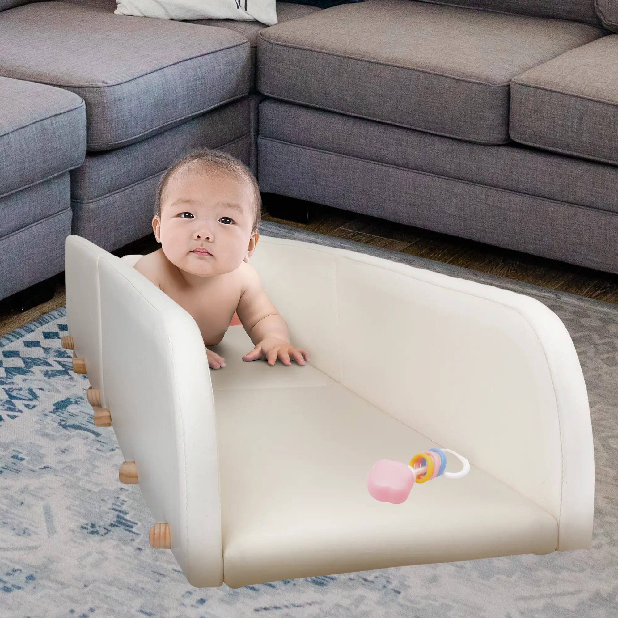 asian infant having fun during tummy time in the crawlaroo infant crawling track and tummy time toy with rubber ducky at the end to encourage early crawling