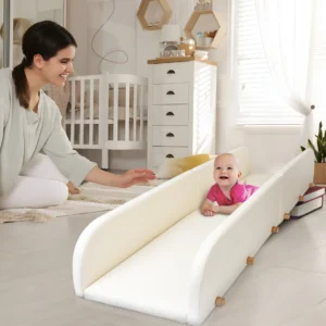 mother holds out a reassuring hand as her baby learns to use the crawlaroo infant crawling track and tummy time toy during tummy time to learn to crawl