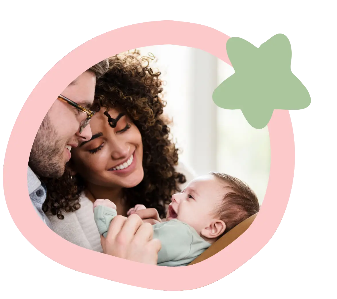 interracial mom and dad look lovingly down at their mixed baby parents